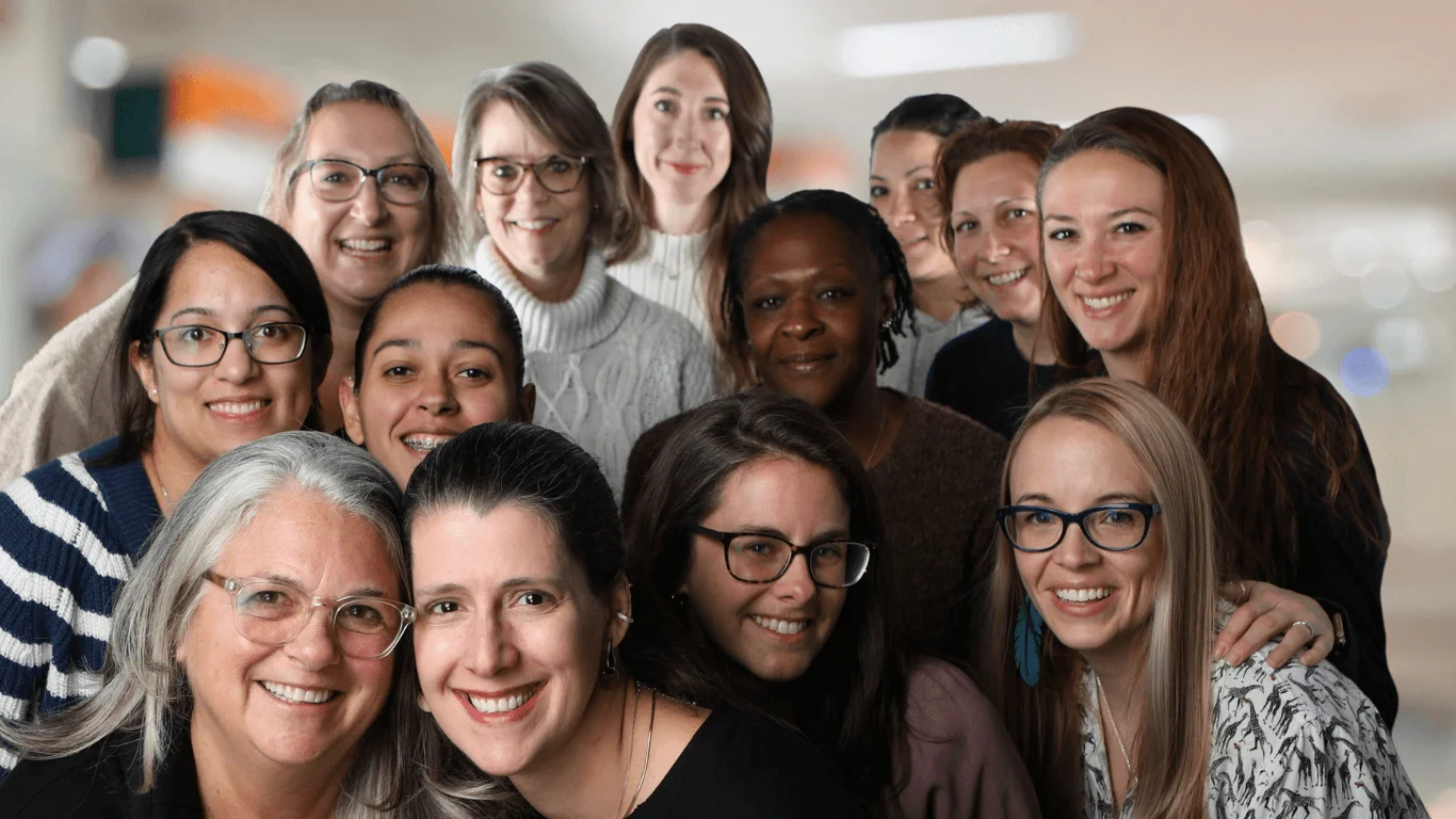 Smiling group of women posing together as an orthodontic clinic team